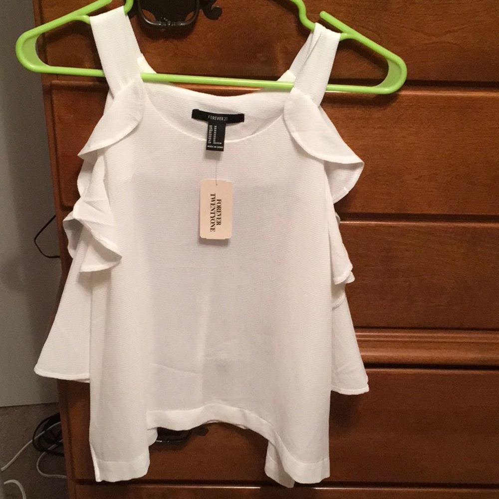Adorable and fun ruffle trim open shoulder top